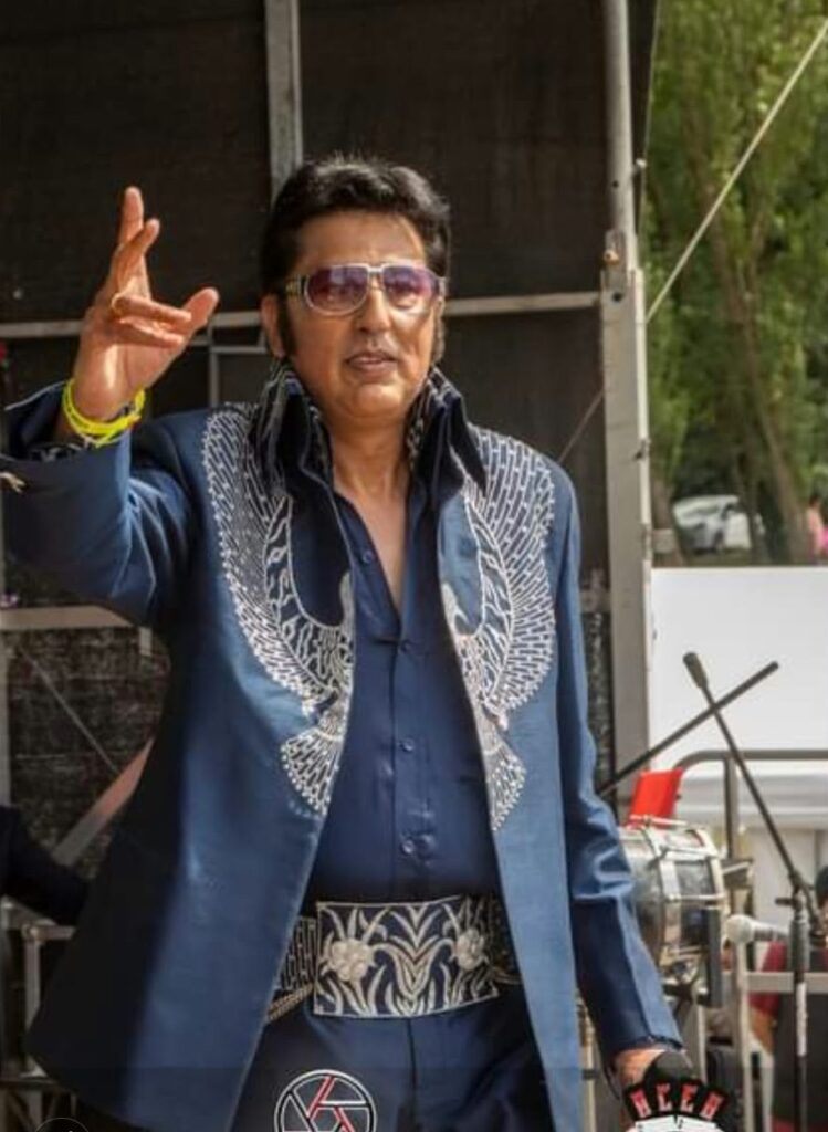 Bal Johal on stage in the blue eagle suit